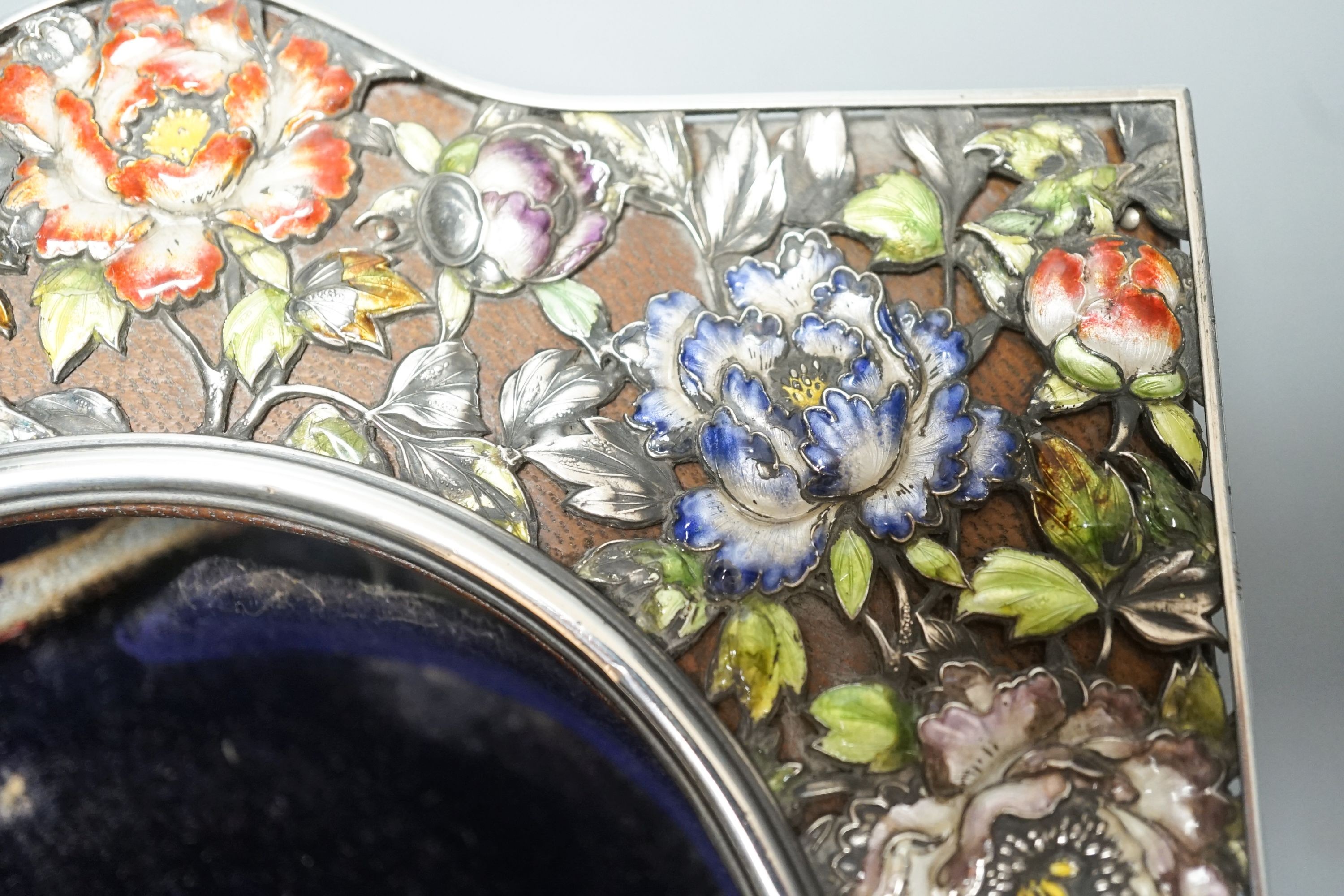 An early 20th century Japanese? white metal and polychrome enamel mounted leather travelling watch case, decorated with flowers and birds, 16.2cm.